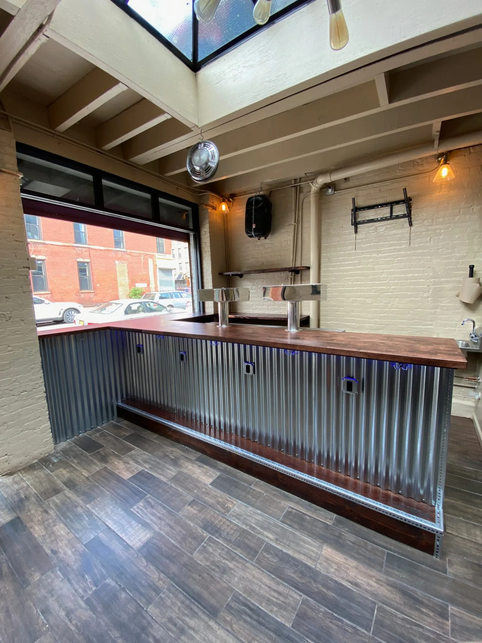 The corrugated-metal bar counter at The Beer Garage in Park Slope, a gluten free beer and cider bar NYC option where every plate from the kitchen is gluten-free