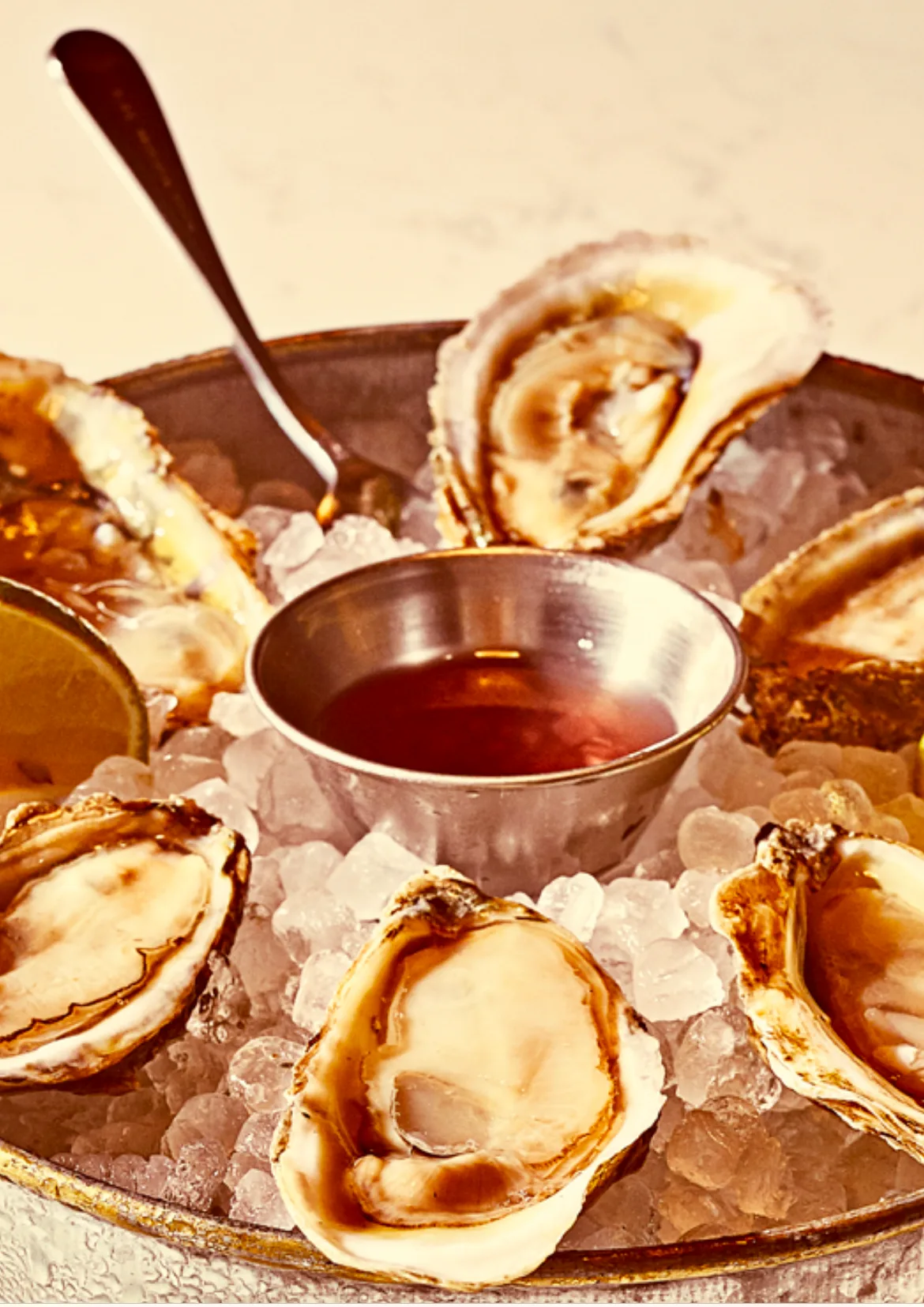A tray of fresh oysters on ice with a cup of mignonette at the West Village bar, the six-piece minimum order at $3 an oyster